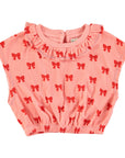 Pink terry top with red bows